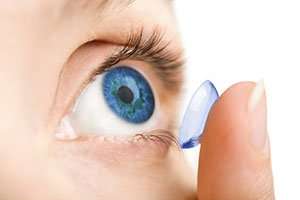 Image of a person putting in contacts.